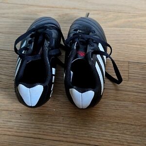 Adidas cleats, child classic black and white 3 stripe.